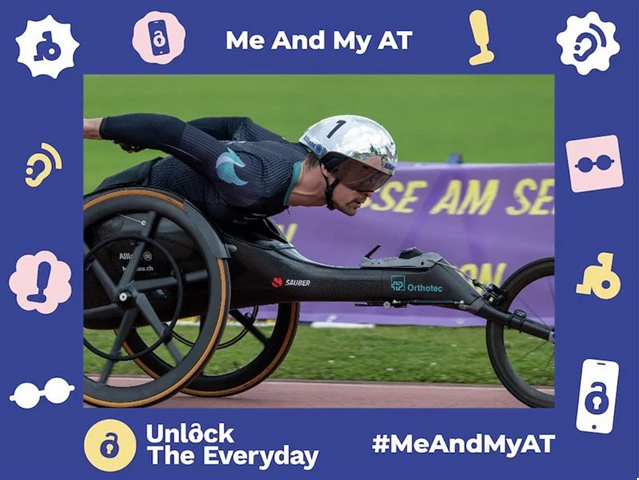 Wheelchair racer in a helmet competing on a track, shown within a ‘Me And My AT’ campaign frame with the text ‘Unlock The Everyday’ and hashtag #MeAndMyAT.”
