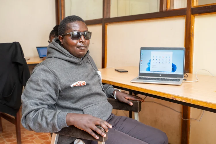 Elijah Karue is able to operate a computer independently, access online resources, and even shop online. Photo: ATscale|Carlisto Ochieng