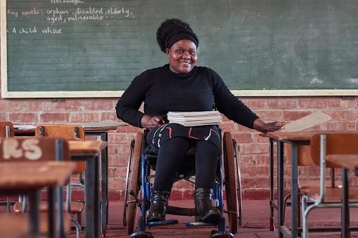 Hope’s wheelchair allows her to work as a teacher. She and other assistive technology users in Zimbabwe now benefit from the amended VAT regulations and import tax exemptions. Photo: MWH