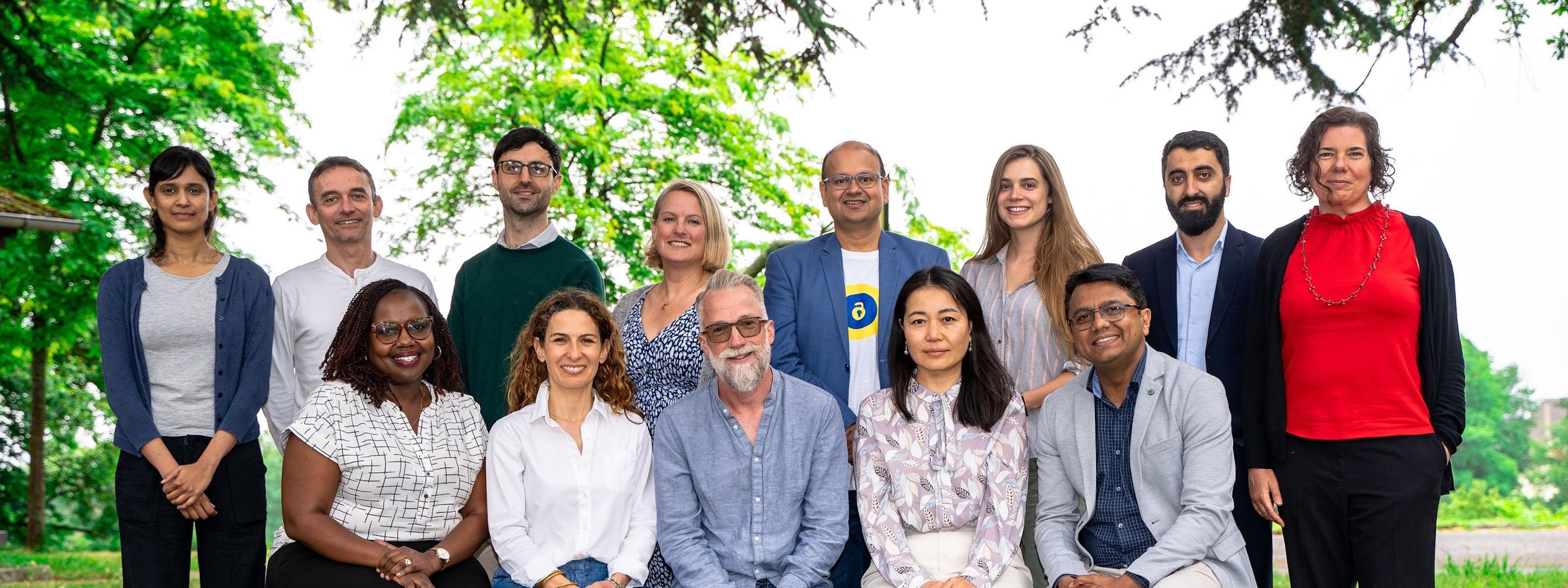 ATscale secretariat members standing together outdoors, posing for a group photo at an event.