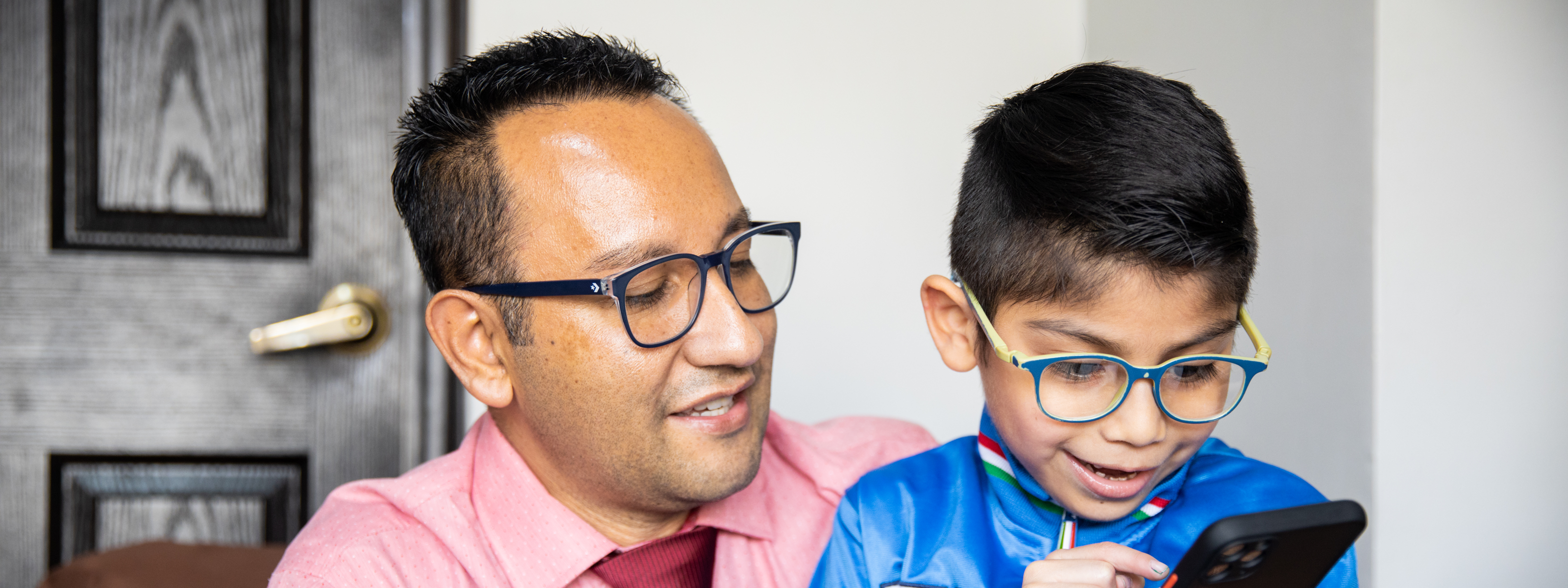 Estuardo Antonio Aquino Sandoval (42 years) shows a picture to his son, Debyan Angel Estuardo Aquino Santiago (7 years old), in their home in Quetzaltenango, Guatemala. Debyan has autism