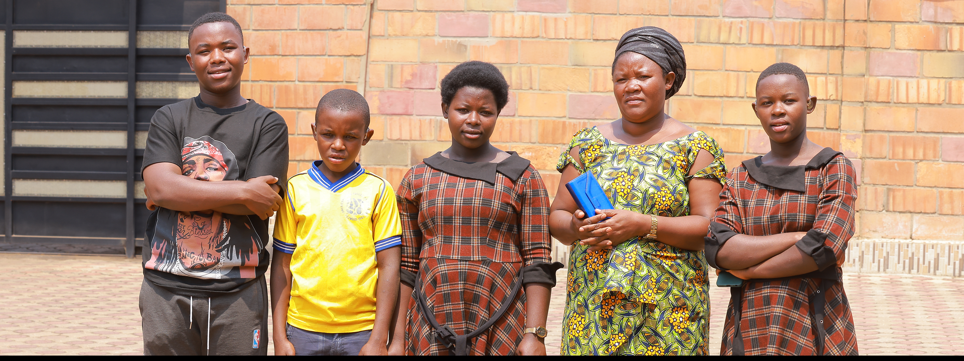 Mrs Jeannette, with her four children, who received digital hearing aids in February 2024.