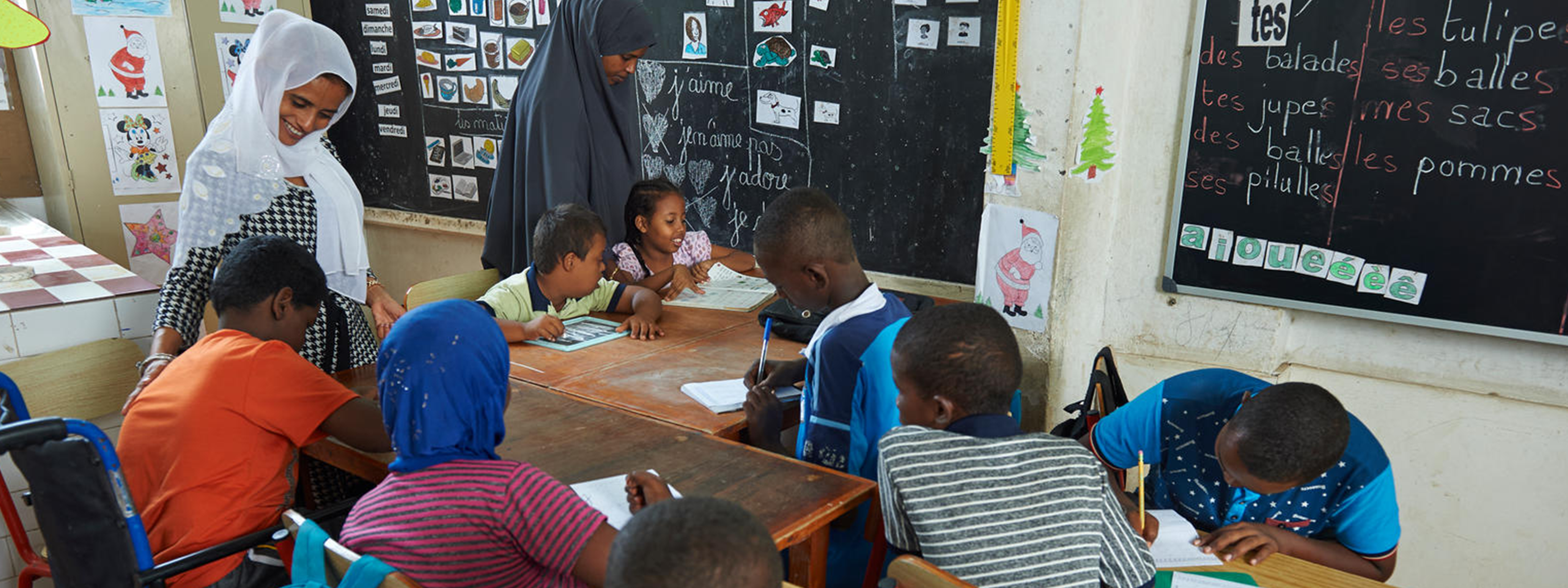 Specially trained instructor works with children with disabilities (special needs) in an inclusive classroom at LEC centre of Boulaos in Djibouti